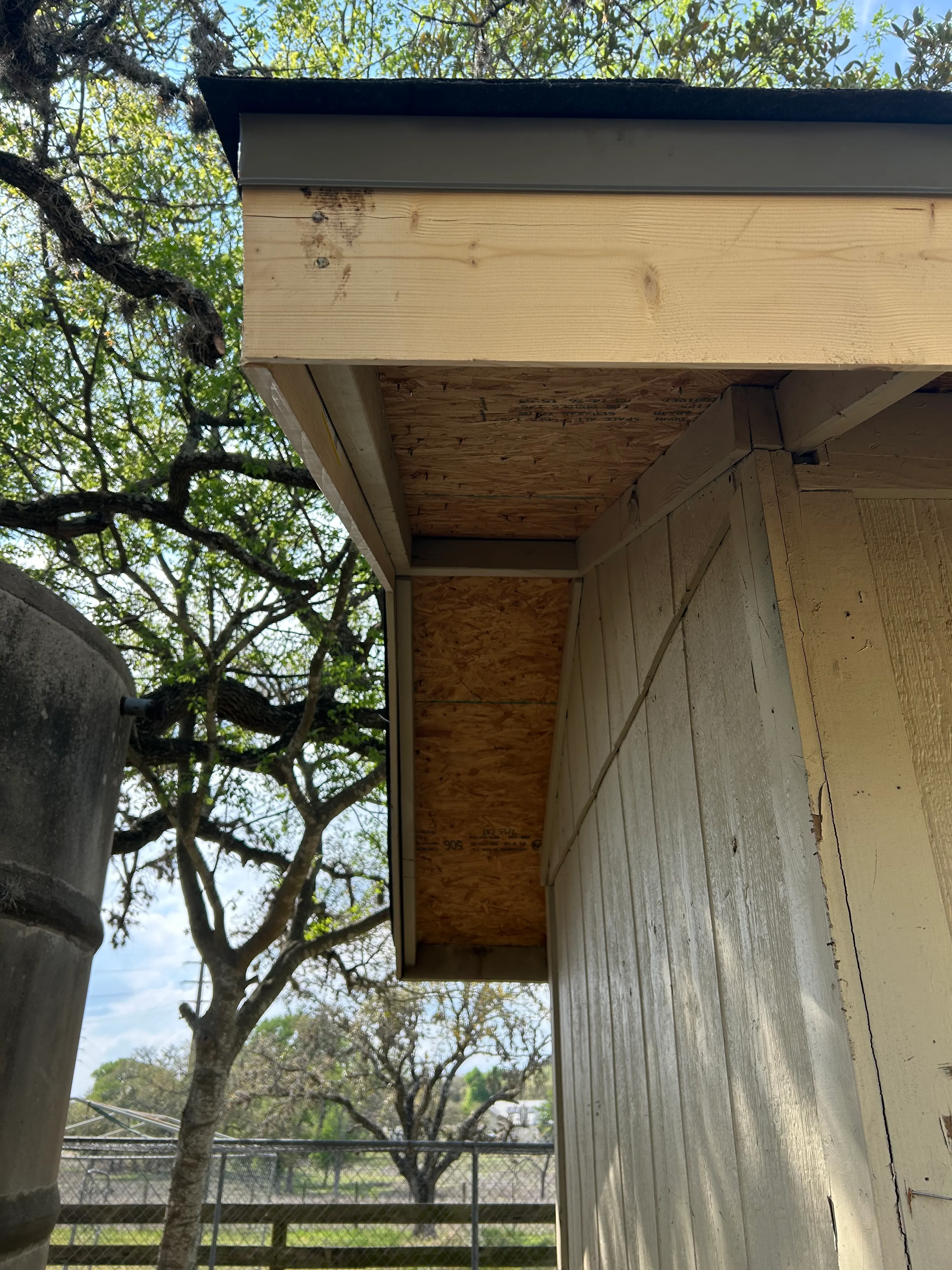 After: new fascia, drip edge, and soffit on a small outbuilding at the roof eave.